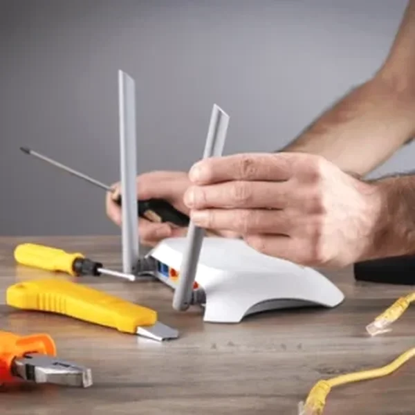 caucasian man repairing wifi router 600nw 2118490280